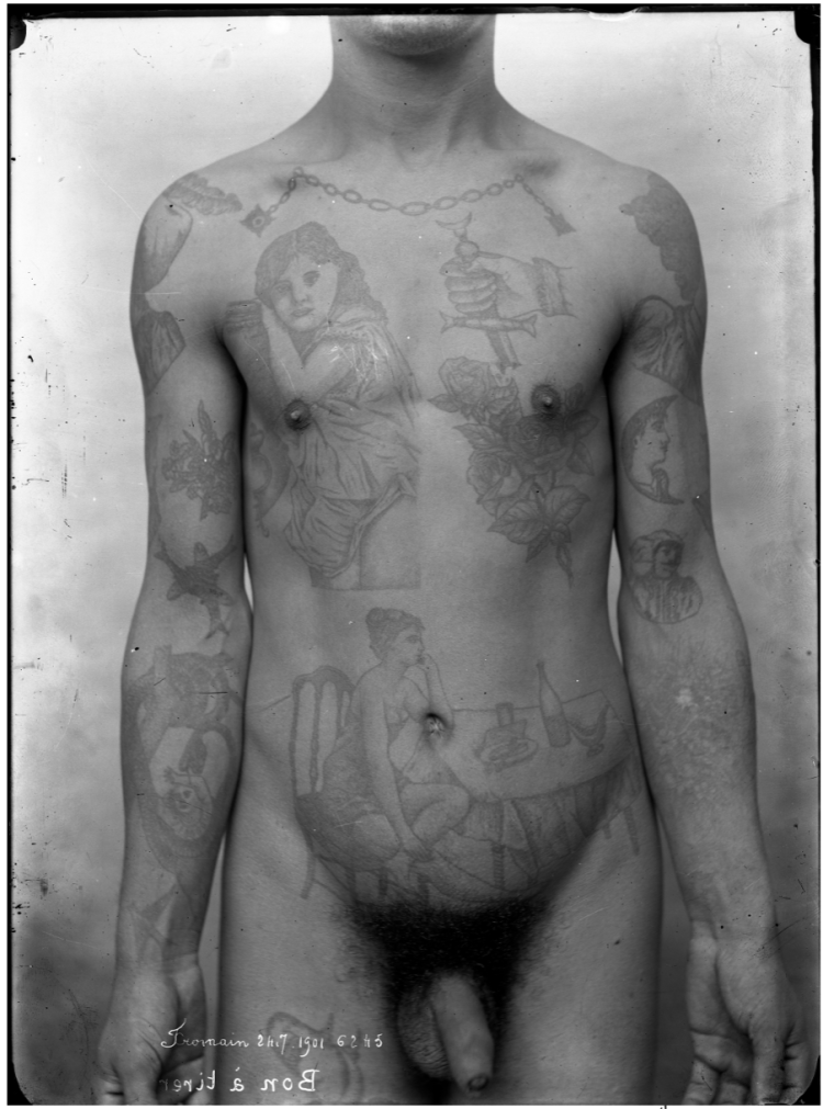 photograph of a tattooed nude white man from the neck down